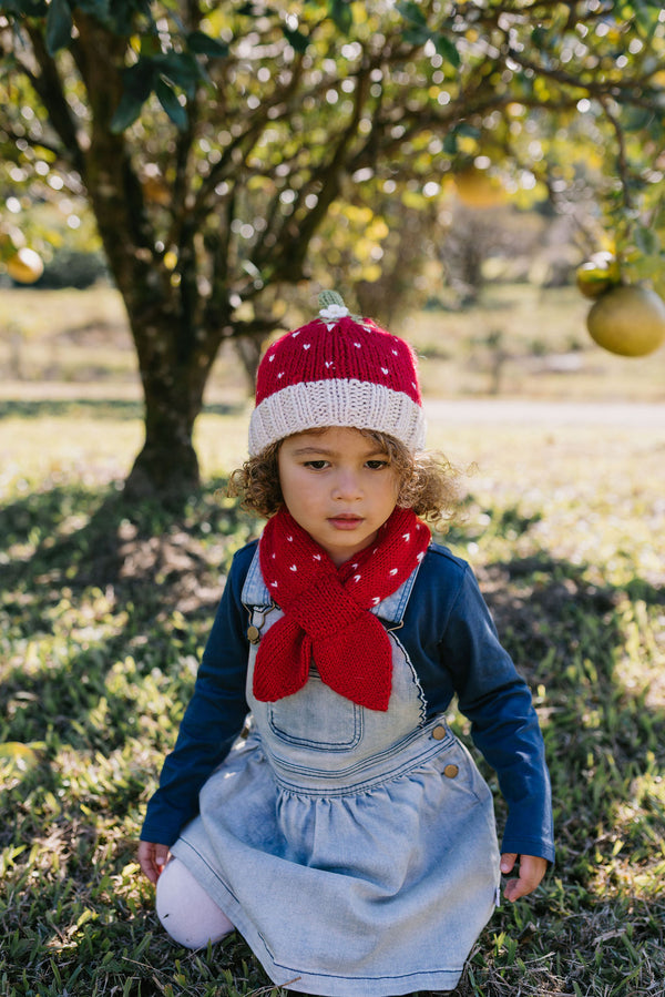 Strawberry Beanie and Cross Over Scarf – kids hand-knitted red and white beanie and scarf with strawberry design in soft wool blend – shown on child - front view - Acorn Kids