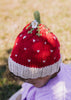 Strawberry Beanie – kids hand-knitted beanie with strawberry, flower, and leaf design in soft wool blend shown on child - top view – Acorn Kids
