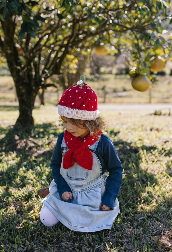 Strawberry Beanie – kids hand-knitted beanie with strawberry, flower, and leaf design in soft wool blend shown on child - side view – Acorn Kids
