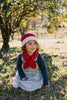 Strawberry Beanie and Cross Over Scarf – kids hand-knitted red and white scarf with strawberry design in soft wool blend – shown on child - front view - Acorn Kids