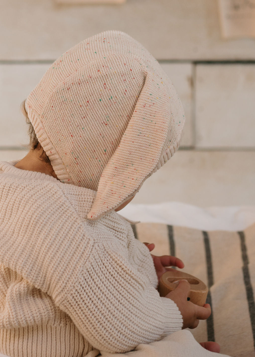 Bunny Beanie Cream – baby and toddler cotton beanie with floppy bunny ears and tie straps on baby back view – Acorn Kids