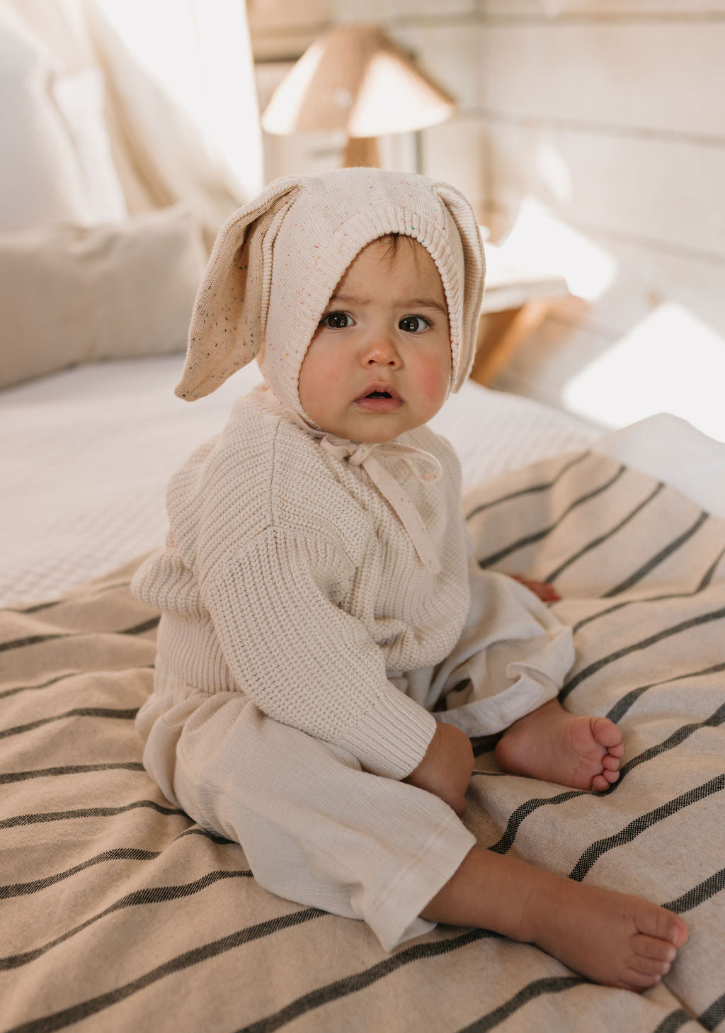 Bunny Beanie Cream – baby and toddler cotton beanie with floppy bunny ears and tie straps on baby front view – Acorn Kids