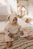Bunny Beanie Cream– baby and toddler cotton beanie with floppy bunny ears and tie straps on baby side view – Acorn Kids
