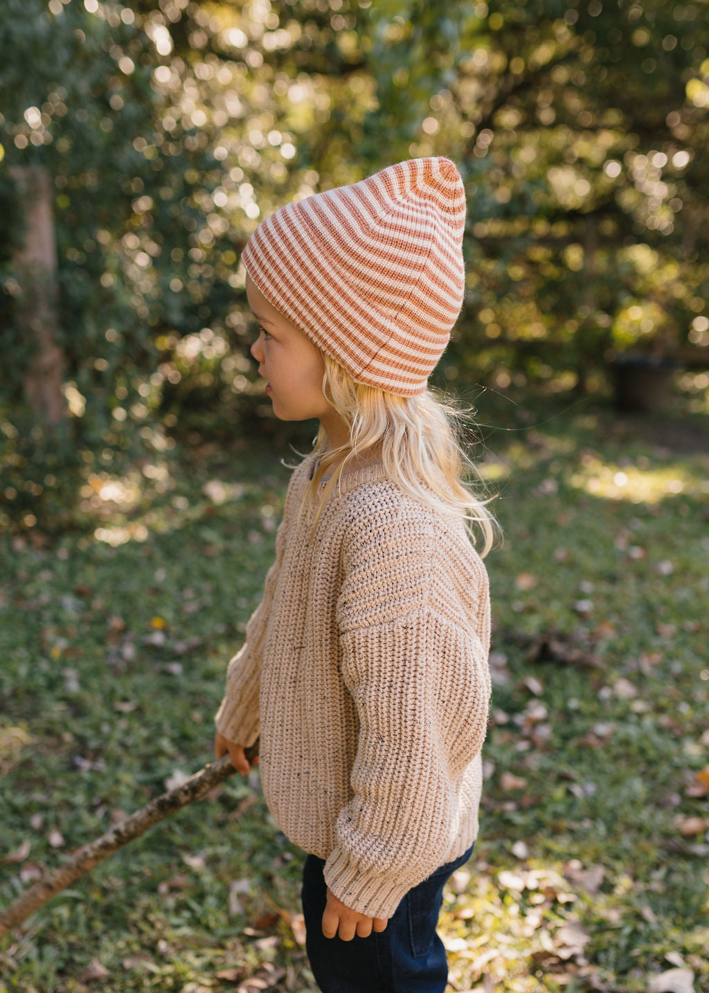 Berlin Merino Beanie Biscuit & Cream Stripe on child side view – kids knitted merino wool striped beanie with pointed top – Acorn Kids