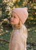 Berlin Merino Beanie Biscuit & Cream Stripe on child side view – kids knitted merino wool striped beanie with pointed top – Acorn Kids