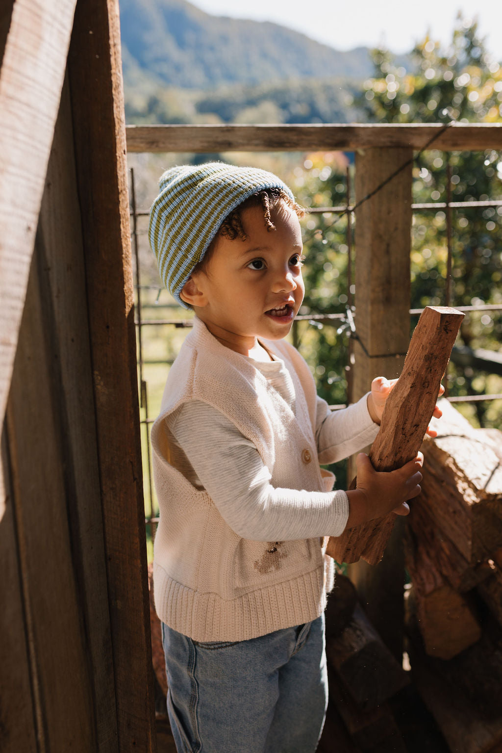 Berlin Merino Beanie Green & Blue Stripe on child side view – kids knitted merino wool striped beanie with pointed top – Acorn Kids