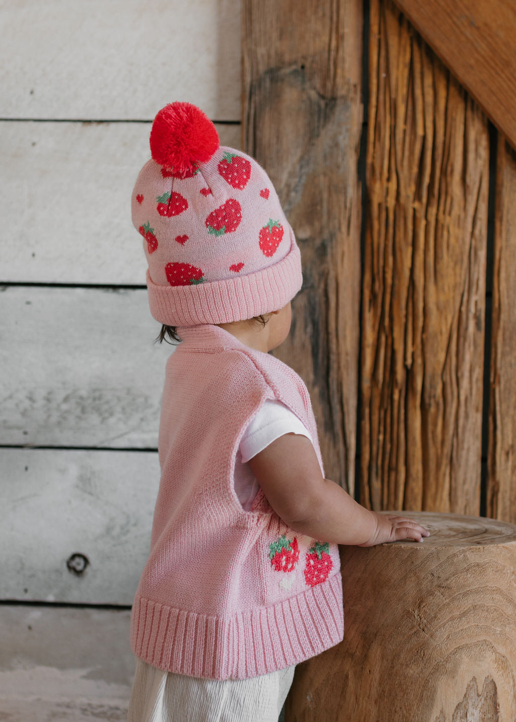 Strawberry Fields Merino Beanie on child back view – kids knitted merino wool beanie with strawberry design and pom pom – Acorn Kids