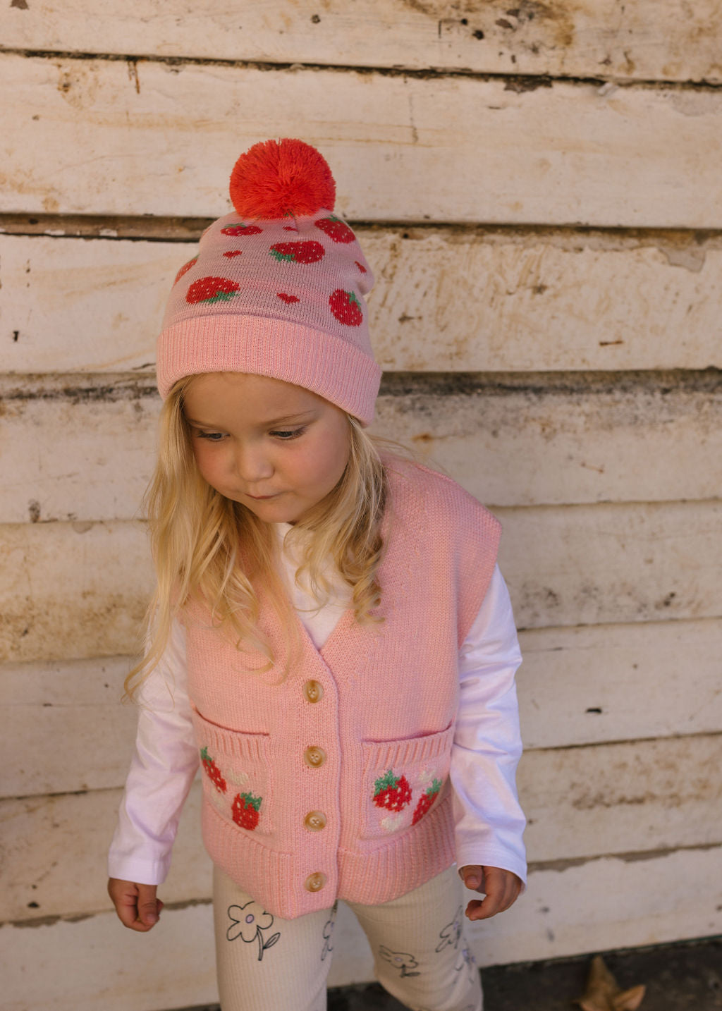 Strawberry Fields Merino Beanie on child front view – kids knitted merino wool beanie with strawberry design and pom pom – Acorn Kids