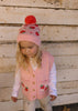 Strawberry Fields Merino Beanie on child front view – kids knitted merino wool beanie with strawberry design and pom pom – Acorn Kids