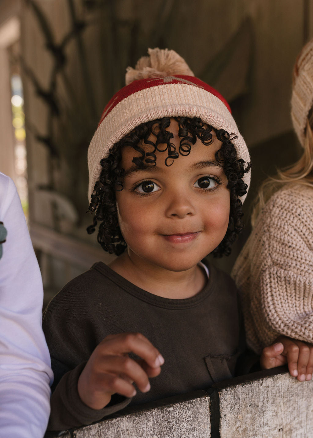 Puppy Dog Merino Beanie on child close up – kids knitted merino wool beanie with sweet puppy dog design – Acorn Kids