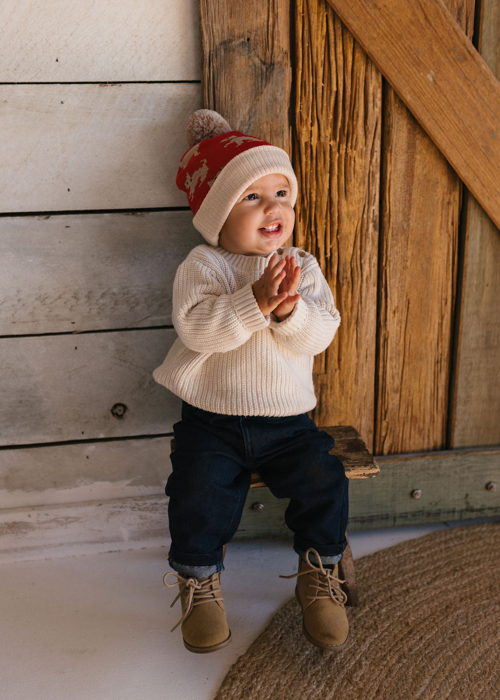 Puppy Dog Merino Beanie on small child full body shot – kids knitted merino wool beanie with sweet puppy dog design – Acorn Kids