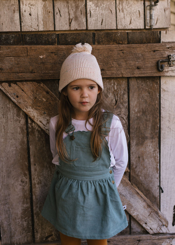 Stargaze Beanie Cream Speckle – shown on child - front view - kids cotton beanie with pom pom and speckled yarn design – Acorn Kids