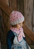Cherry Beanie – kids hand-knitted pink beanie with crochet cherry and soft wool blend shown on child - top view – Acorn Kids