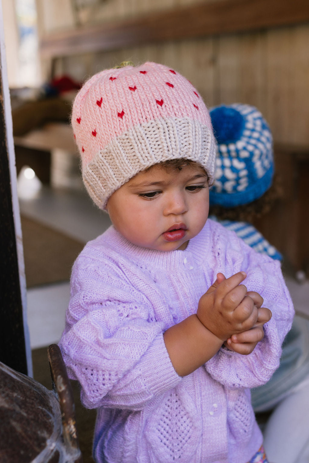 Cherry Beanie – kids hand-knitted pink beanie with crochet cherry and soft wool blend shown on young child - front view – Acorn Kids