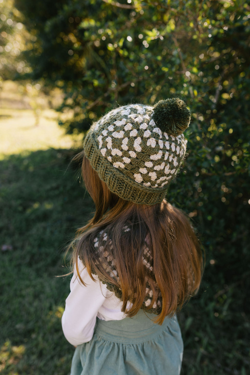 Boho Beanie Khaki – on child back view kids hand-crocheted beanie with two-tone granny square pattern and pom pom – Acorn Kids