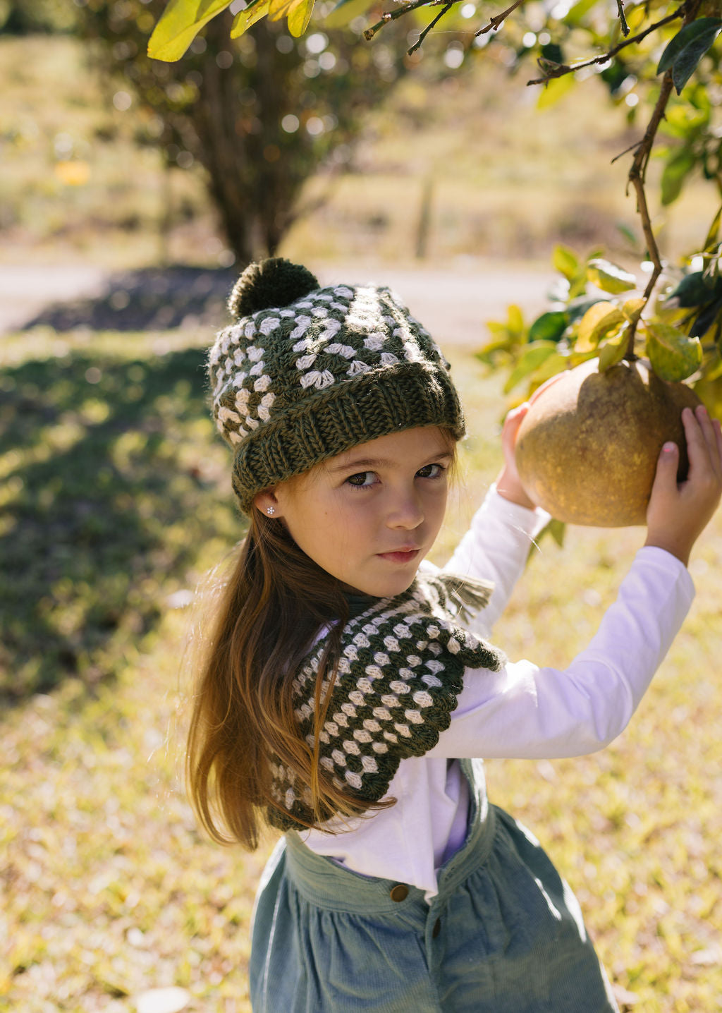 Boho Beanie Khaki on child front view – kids hand-crocheted beanie with two-tone granny square pattern and pom pom – Acorn Kids