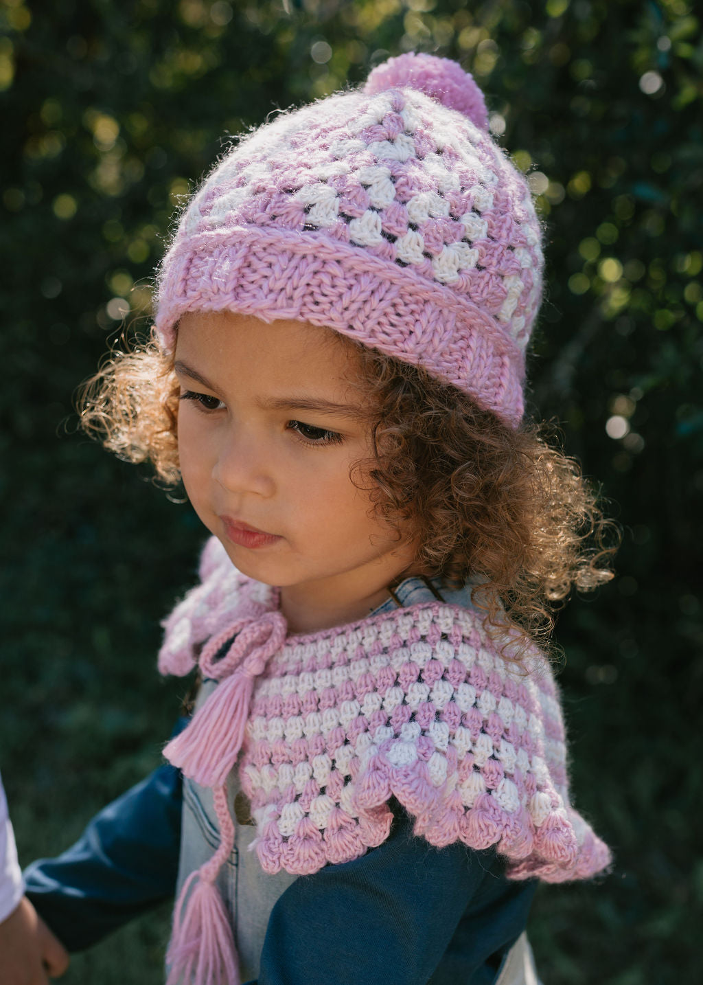 Boho Beanie and Collar Pink on child side view – kids hand-crocheted beanie and collar scarf with retro stripes and scalloped edge – Acorn Kids