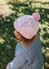 Boho Beanie Pink on child side view – kids hand-crocheted beanie with two-tone granny square pattern and pom pom – Acorn Kids