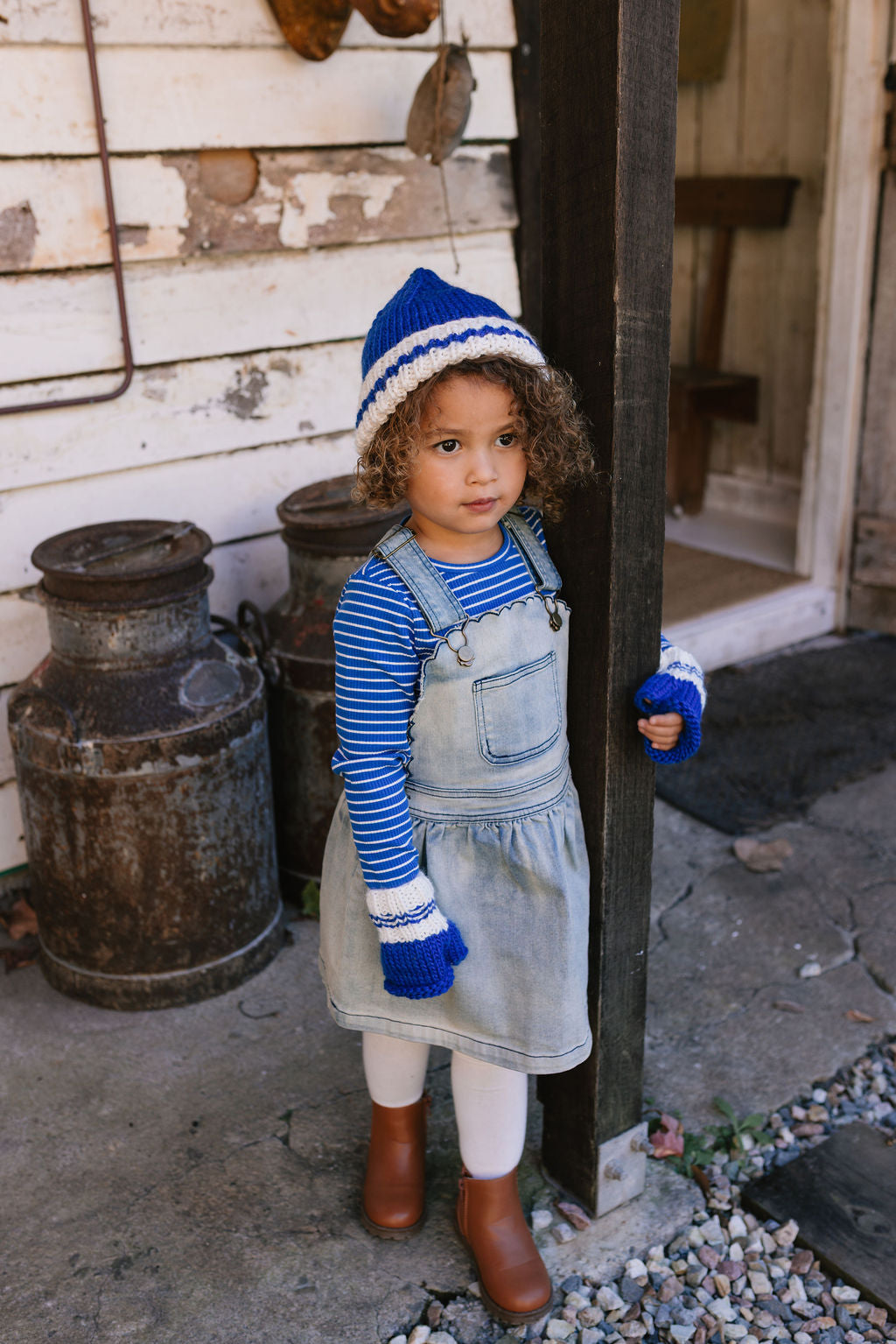 Child wearing Denmark Beanie Blue & Cream front view – kids striped knit beanie with pointed crown – Acorn Kids