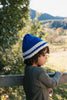 Child wearing Denmark Beanie Blue & Cream side view close up – kids striped knit beanie with pointed crown – Acorn Kids 