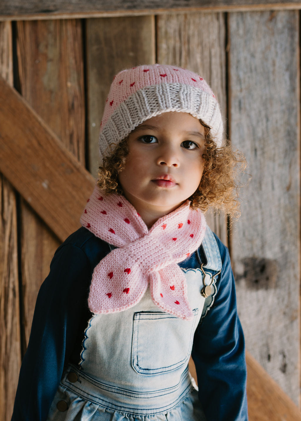 Cherry Cross Over Scarf – front view - kids hand-knitted cross over scarf in pink and red wool blend – Acorn Kids
