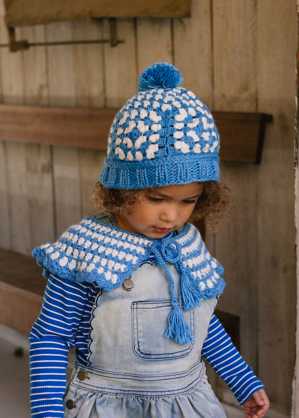 Boho Beanie and Collar Blue on child front view – kids hand-crocheted beanie and scarf with retro stripes and scalloped edge – Acorn Kids