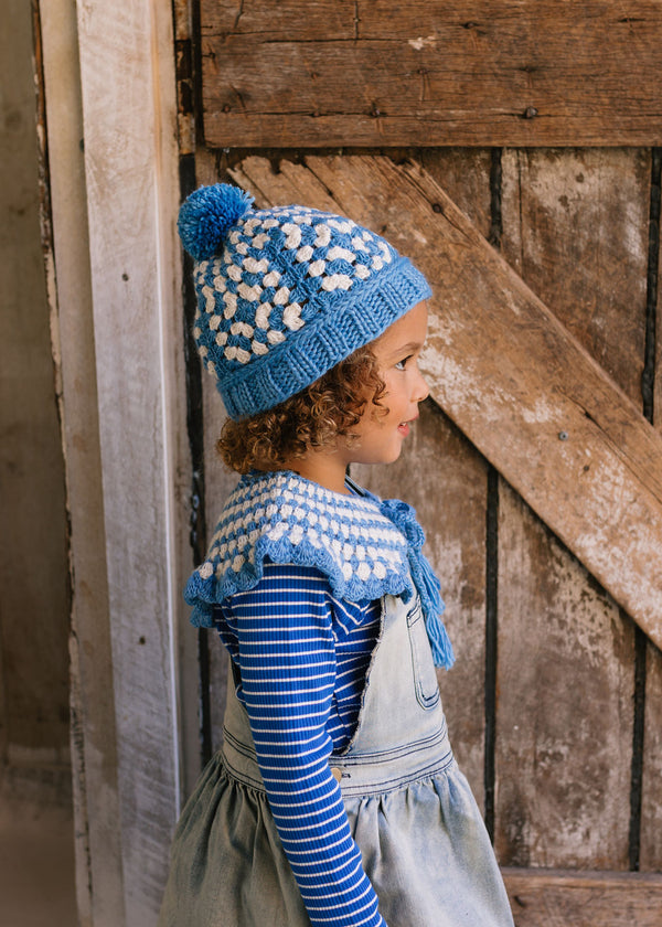 Boho Beanie and Collar Blue on child side view – kids hand-crocheted beanie and scarf with retro stripes and scalloped edge – Acorn Kids