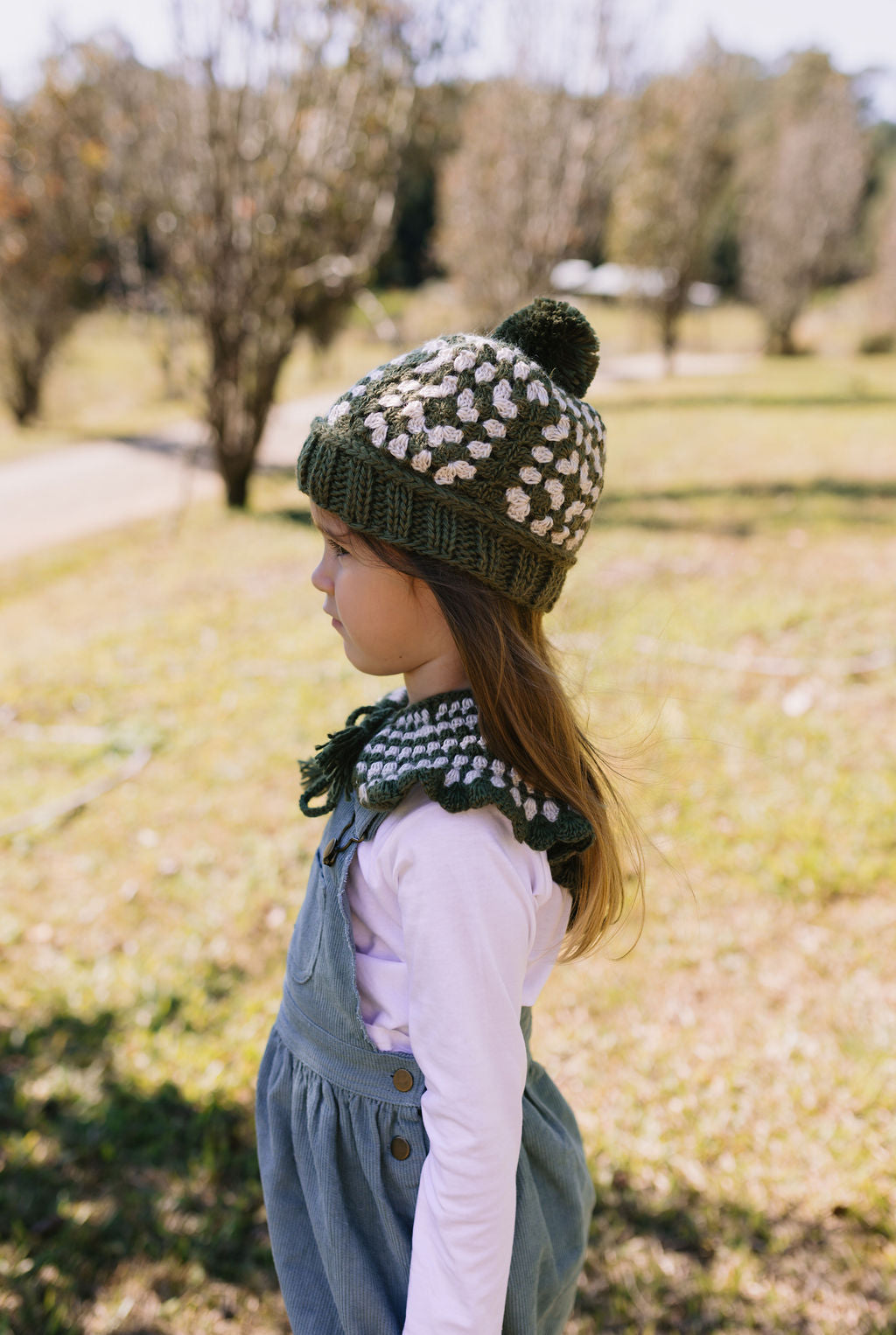 Boho Beanie and Collar Khaki on child side view – kids hand-crocheted beanie and scarf with retro stripes and scalloped edge – Acorn Kids