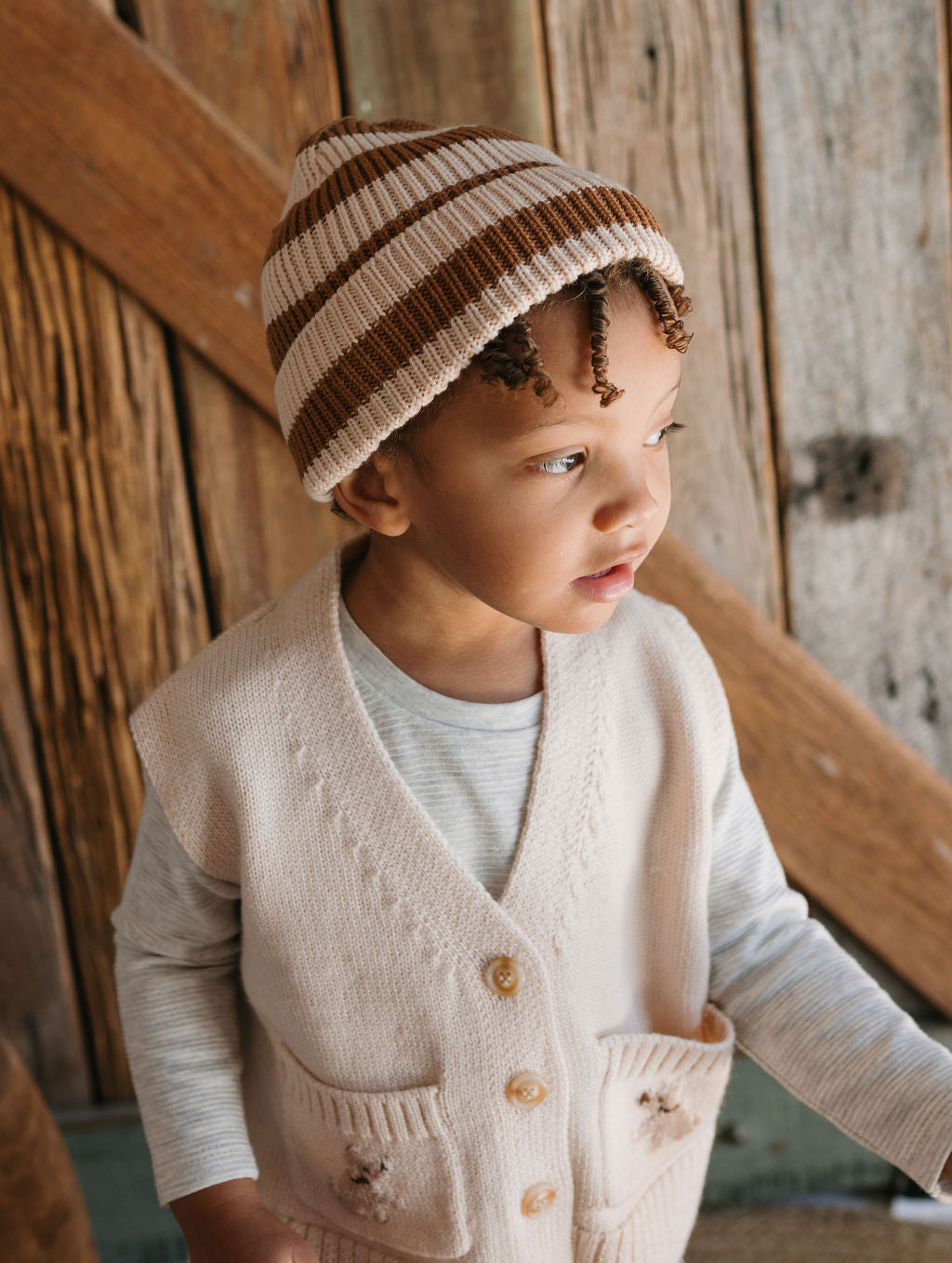 Puppy Merino Dog Vest on child close up – kids knitted merino wool vest with puppy design and front pockets – Acorn Kids